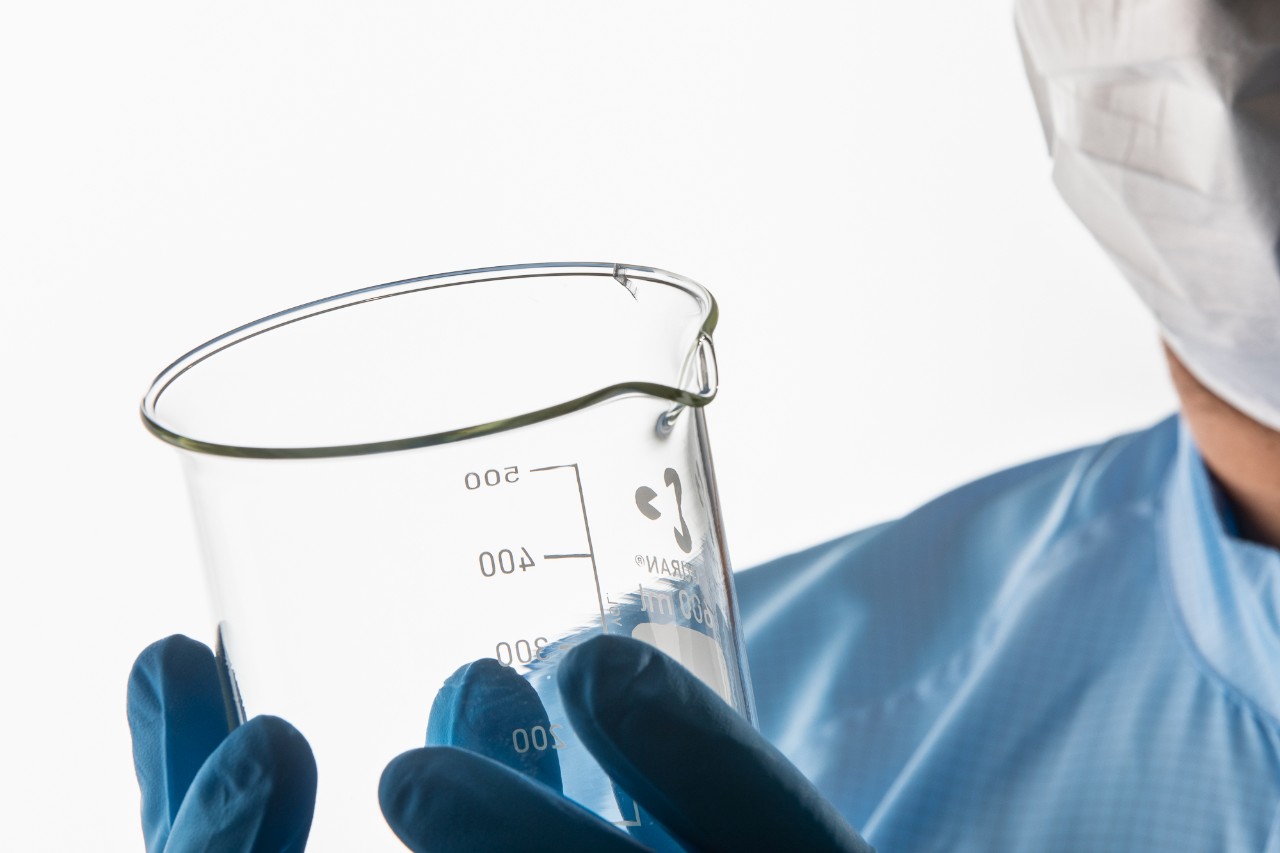 Scientist inspecting laboratory glassware