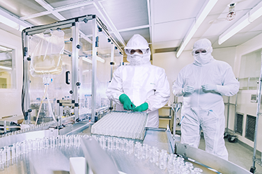 Laboratory workers wearing aseptic donning with disposable coveralls